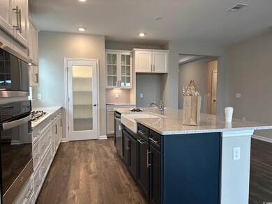 Kitchen with stainless steel appliances, dark hard
