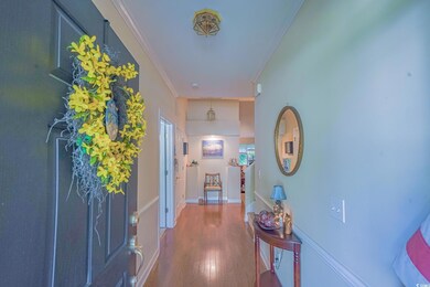 Interior space with crown molding and hardwood / w