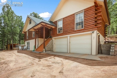 View of front of home featuring log siding, a garage, stairway, and driveway