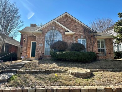 View of front of property with brick siding and a 