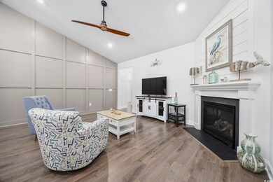 Living room with ceiling fan, lofted ceiling, and 