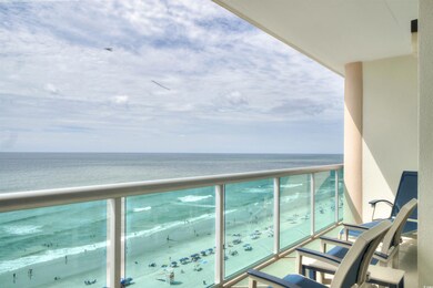 Balcony with view of water and beach