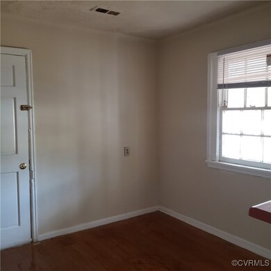 Empty room featuring hardwood / wood-style floorin