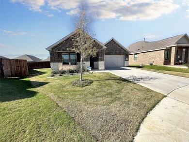 View of front of house featuring a garage and a front lawn