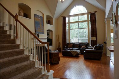 Impressive family room! Soaring ceilings, beautiful wall of windows, hardwoods.
