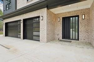 Doorway to property with brick siding, an attached