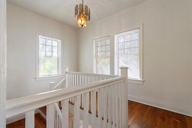 Stairway with hardwood / wood-style floors and ba