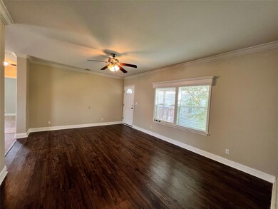 Empty room featuring ceiling fan, dark wood-style