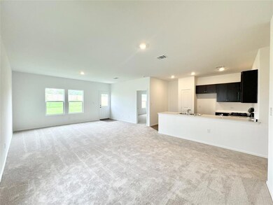 Unfurnished living room featuring light colored carpet and recessed lighting