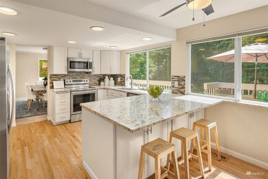 The remodeled kitchen features granite countertops, stainless steel appliances and countertop seating for casual dining.