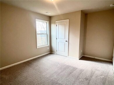 Unfurnished bedroom with baseboards and carpet floors