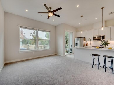 Kitchen featuring light carpet, appliances with s