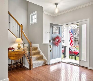 Foyer leading into home with hardwood throughout 1