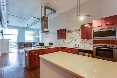Kitchen with stainless steel appliances, a peninsu