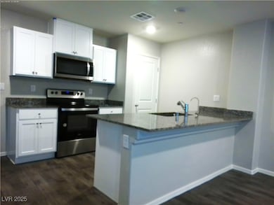 Kitchen with stainless steel appliances, dark wood