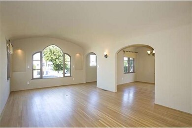 Living Room with Barrel Ceiling and Hardwood Floor