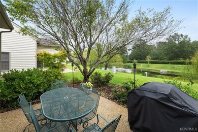 View of patio with a grill and a water view