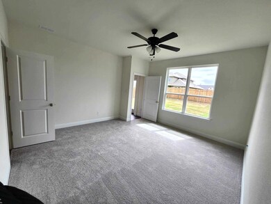 Empty room with light carpet and ceiling fan
