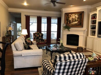 Living room with fireplace and view of back patio area