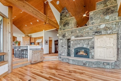The grand stone fireplace is the centerpiece of th