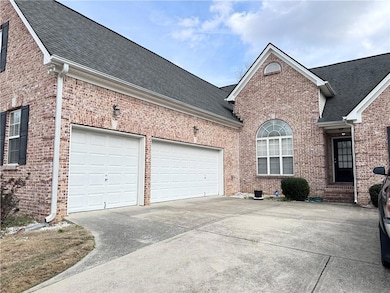 View of front facade with brick siding, driveway, 