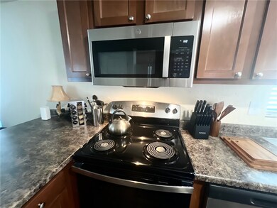 Kitchen featuring stainless steel appliances and countertops