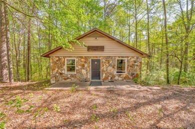 View of front of house with a view of trees and st