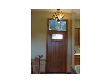 Entryway. Arts and Crafts wood front door with tra