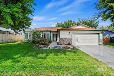Single story home with concrete driveway, stone siding, and a garage