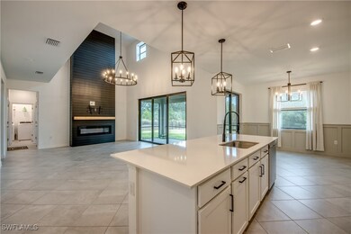 Kitchen with a sink, a chandelier, open floor plan