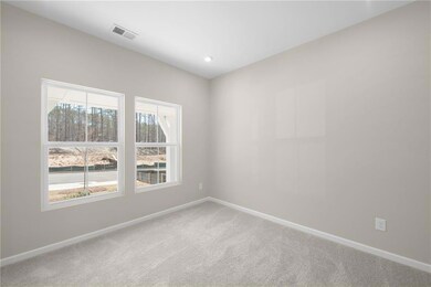 Spare room featuring baseboards, light carpet, a h