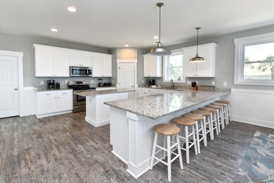 Kitchen featuring a kitchen bar, white cabinetry, 
