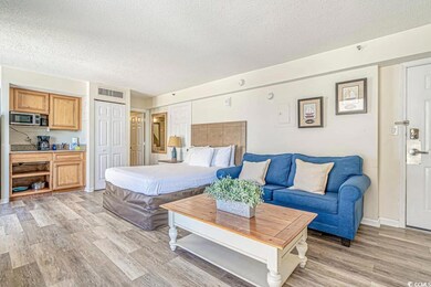 Bedroom featuring visible vents, light wood-style 