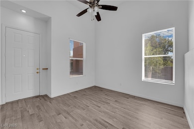 Unfurnished room featuring light wood-type flooring and a ceiling fan