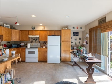 Kitchen featuring a healthy amount of sunlight and white appliances