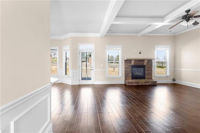 Unfurnished living room with beamed ceiling, dark 