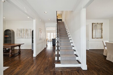 The pretty entry and main hallway open to a formal