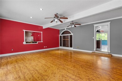 Empty room with baseboards, beamed ceiling, a ceil