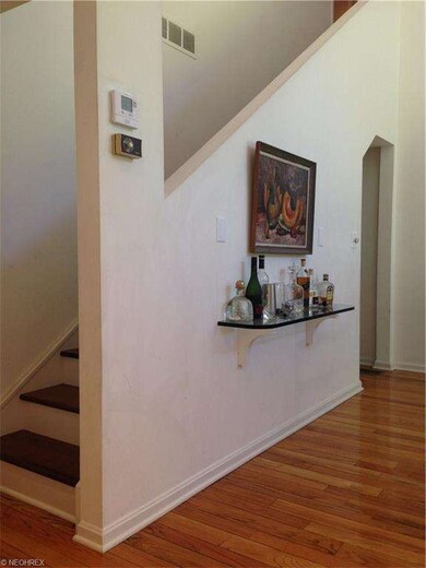 Archway to garage and backdoor closets. Stairs up 