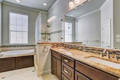 PRIMARY BATH - Features granite top vanities and two sinks, a relaxing tub and wonderful separate glass enclosed shower. You might linger here longer than usual . . .