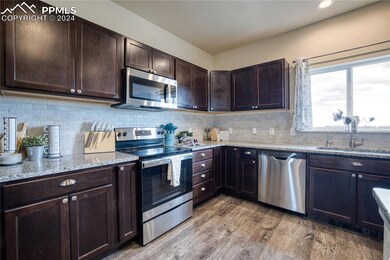 The Kitchen features luxury vinyl plank floors, es