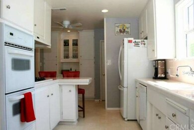 Bright kitchen with built-in appliances and breakf