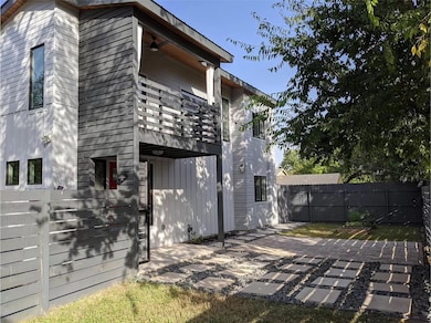 Rear view of house with fence, a patio area, and 