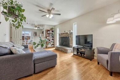 This family room features a cozy stone fireplace, 
