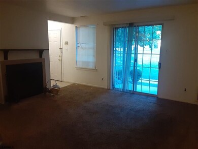 Living room with sliders overlooking open space. W
