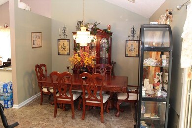 Dining space featuring lofted ceiling and baseboards