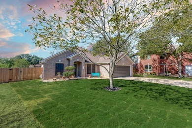 View of front of property with brick siding, driv