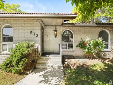Entrance to property with a tile roof and brick siding