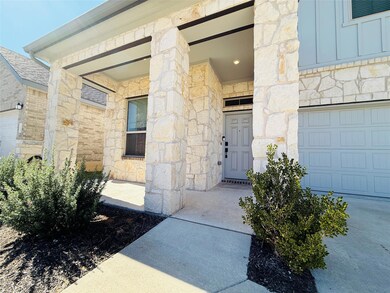 Property entrance featuring stone siding and board and batten siding