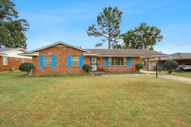 Ranch-style house featuring a front lawn